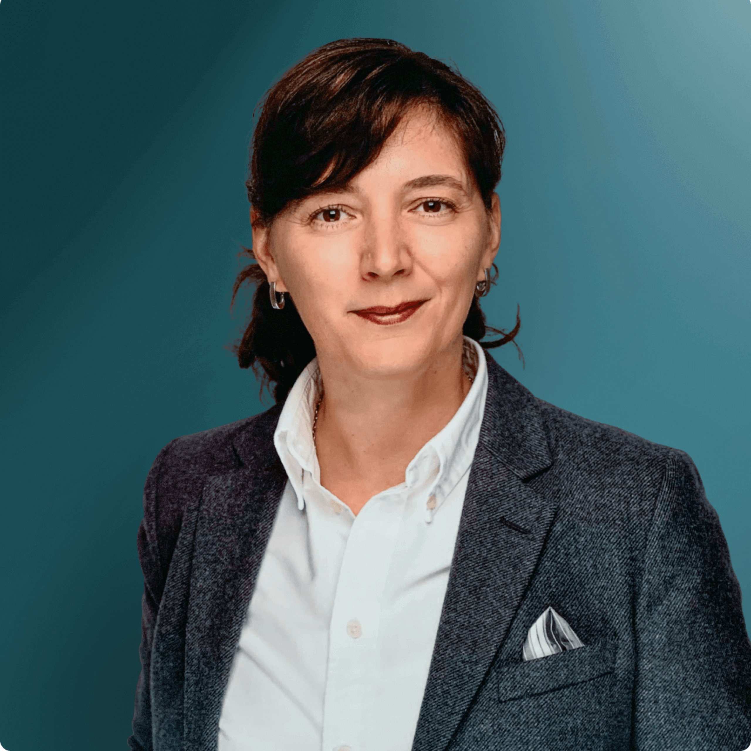 Ansprechpartnerin für den OXG Glasfaserausbau in Kommunen, in formeller Kleidung vor einem blauen Hintergrund